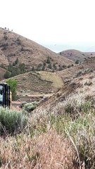 Construction Workers Demolish A Hilltop