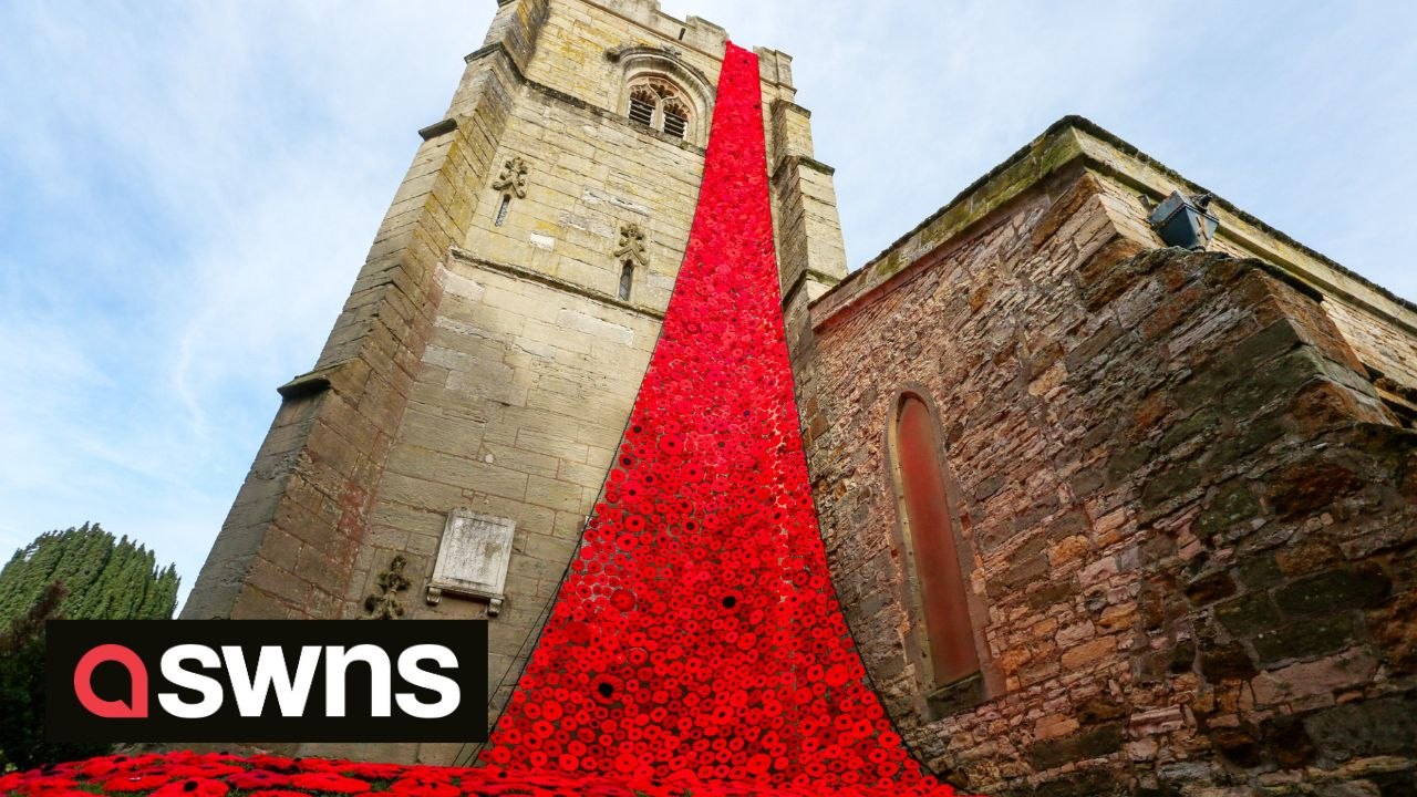Huge cascade of thousands of knitted poppies pour from church ready for Remembrance Day