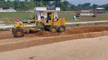 Motor grader working on a horse racing track improvement project