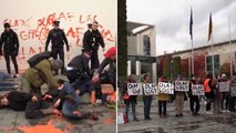 Climate activists paint message to German chancellor during latest Berlin protest