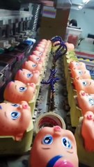 Eyes Stamped Onto Dolls at Factory