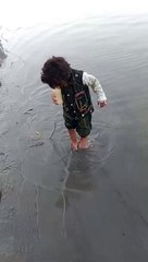 Baby playing with fish in Sindhu lake  of D. I. Khan