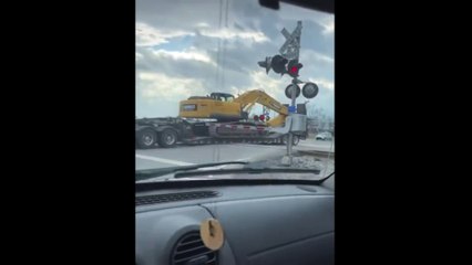 WARNING: Truck driver gets stuck on train tracks