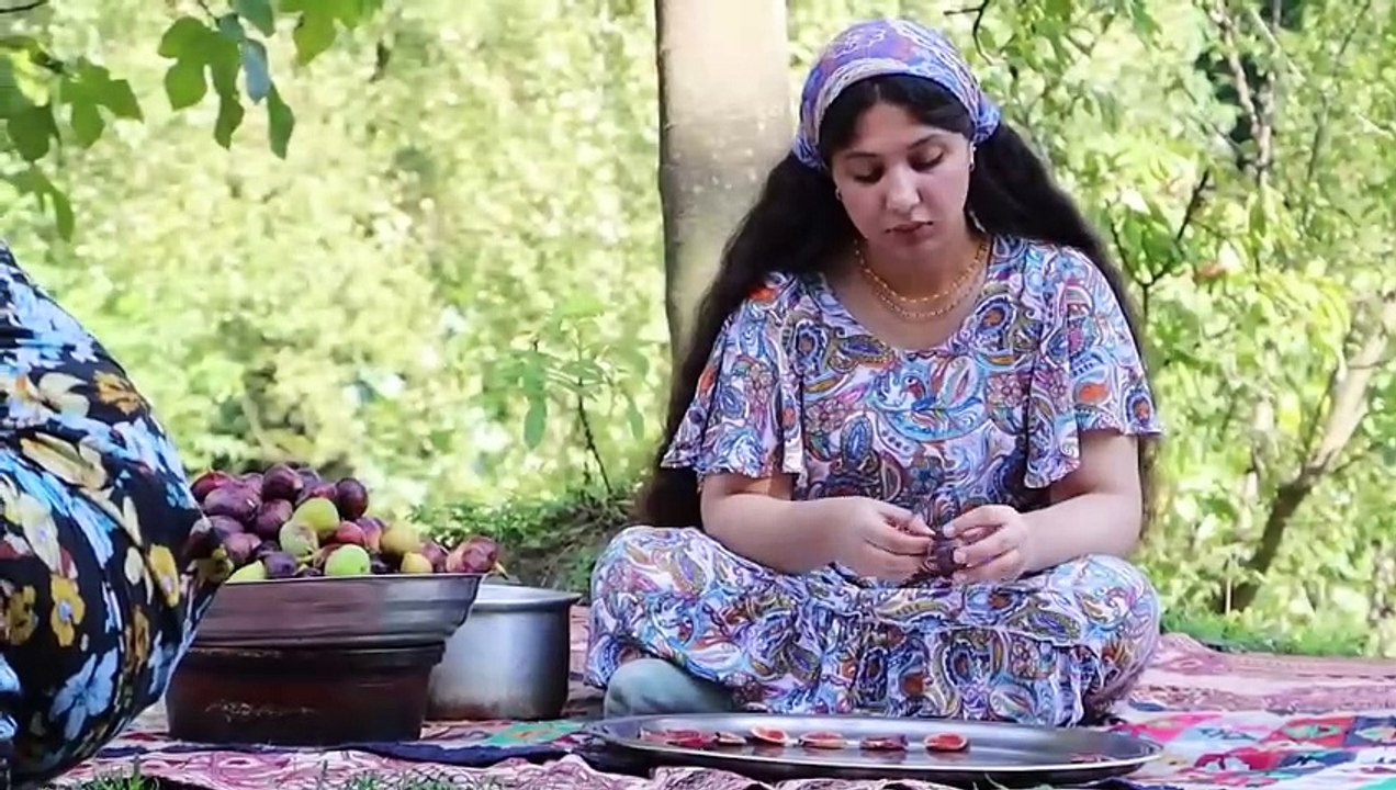The village mother and daughter cook delicious jam from the figs picked from the tree