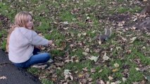 Girl is pleasantly surprised after squirrels accept her feeding invitation