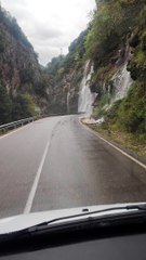 Heavy Rain Creates a Waterfall Over Road