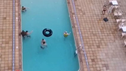 Man brings excitement to the table with an absurd dolphin dive into the pool