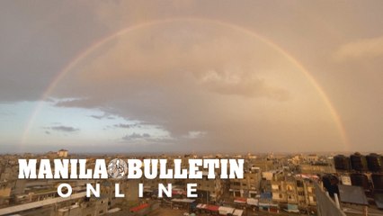Rainbow appears in sky above Rafah at sunrise