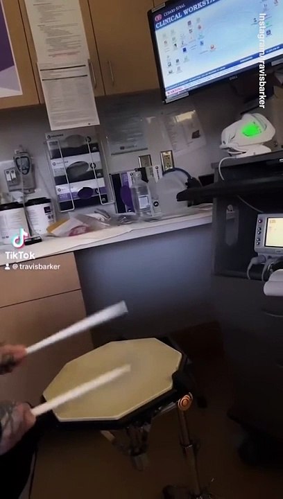 Travis Barker drums on a stool to the beat of his son's heart