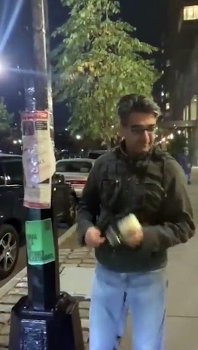 Man covers up posters of Israeli hostages in NYC