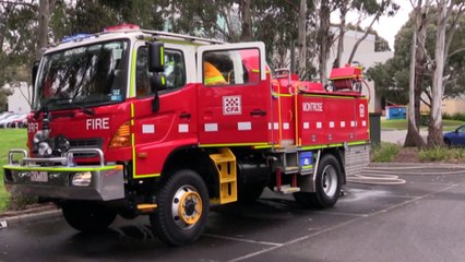 Volunteer firefighters riding in outdated trucks
