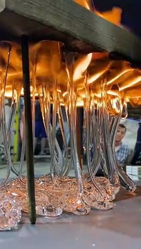 Dripping Molten Glass Over a Wooden Board With Holes