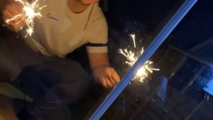Cute baby is captivated by the enchanting fireworks display in the garden