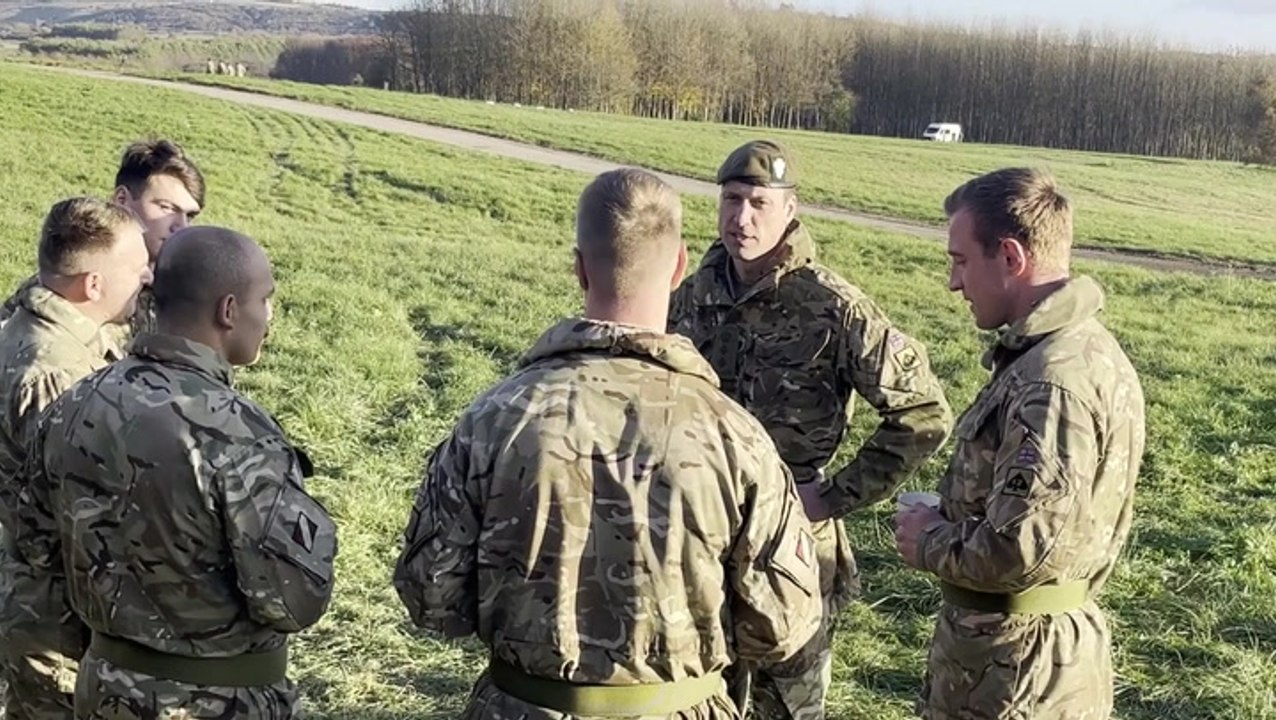 Prince of Wales throws smoke grenades during military mock attack
