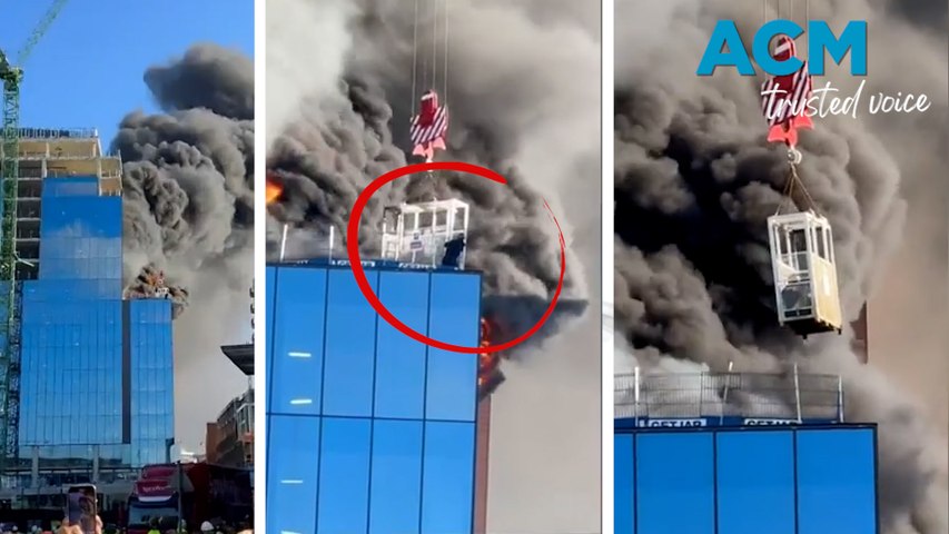 Dramatic footage from a construction site in Reading, U.K., shows the moment that a worker was rescued from the roof of a building engulfed by flames.