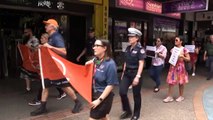 Service workers, police and more march in Darwin for UN campaign against gender-based violence