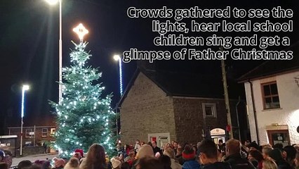 Watch as Llanbadarn village turn on their Christmas tree lights and local youngsters sing