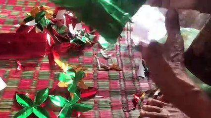 Grandmother uses paper to make baray flowers