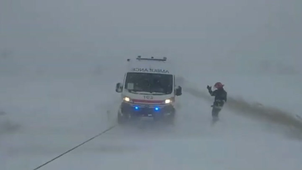 Ukrainian emergency workers tow ambulance from snow as storm kills at least five