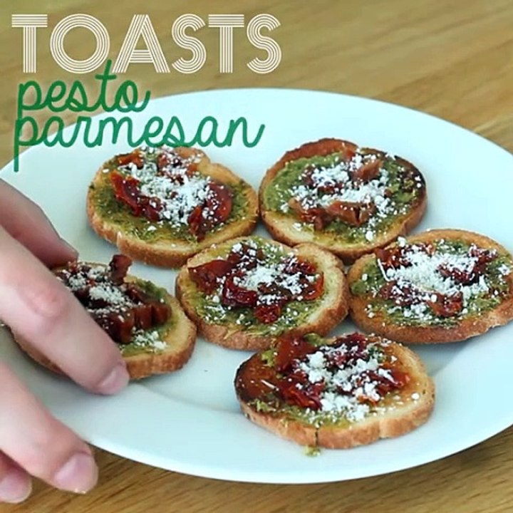Toasts with pesto, parmesan, and sun-dried tomatoes