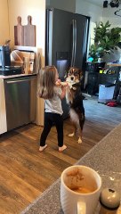 Girl Sweetly Serenades Dog