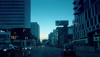 Vertical Panning Shot Of Traffic Lights And Street Sign At Downtown.