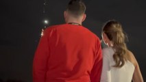 Excited couple embraced by elation in fire-tastic gender reveal moment