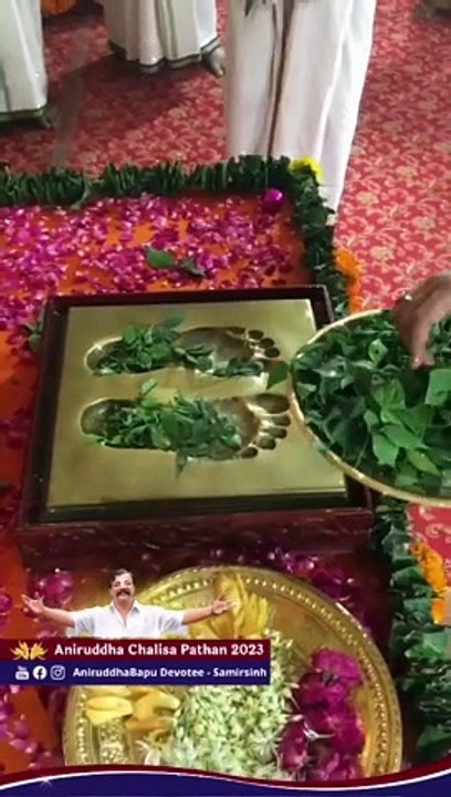 Offering of flowers, tulsi and bilva leaves to the Charan Mudra of Sadguru  Aniruddha Bapu