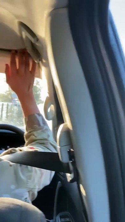 Car driving through deep flooded water on Thorney Island causeway