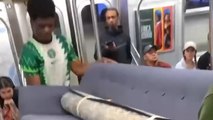 Two guys carry sofa into a NYC train!