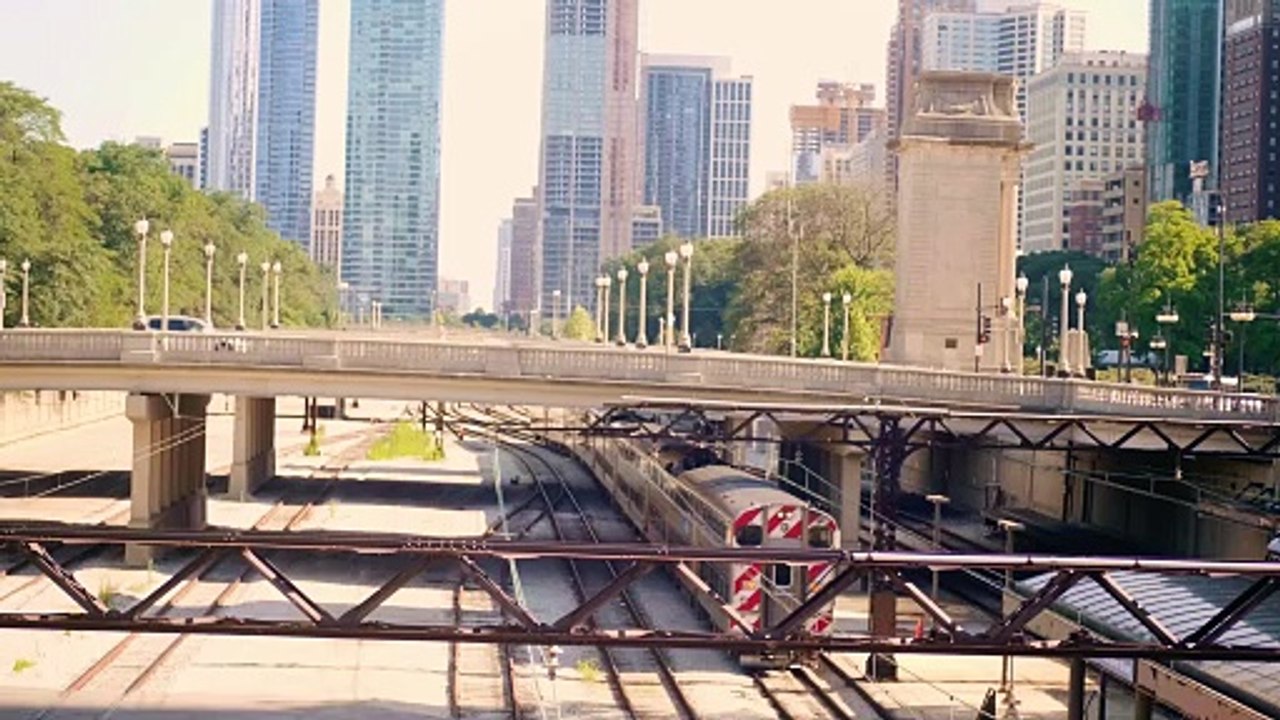 Aerial View Of Train Station With Street And Buildings In Background.