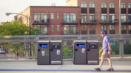 Runners And Cyclists On Footbridge With Trash Containers.
