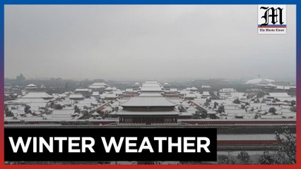 Beijing residents enjoy the first snow in China's capital
