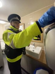 Sgt Dan Lewis conducting a drug wipe in one of the premises toilets