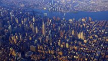 Aerial flyover of downtown New York city at sunset.