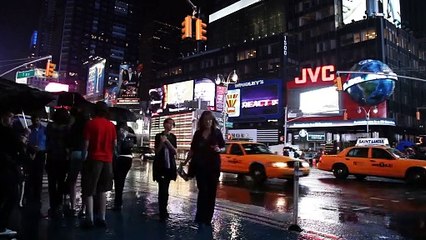 Times Square during a rainy day at night.