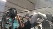 Man Struggles to Lift Weight While Doing Decline Bench Press at Gym