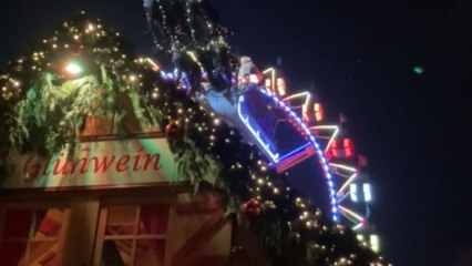 Santa Claus in his sleigh flying on Christmas market at Opernpalais