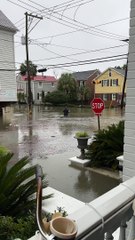 Fully Suited Man Wades Through Floodwater