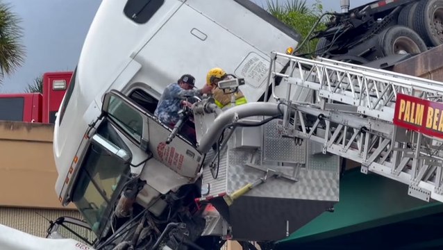 Watch moment driver rescued from dangling truck cab over busy highway