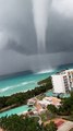 Waterspout Towers Over Shore