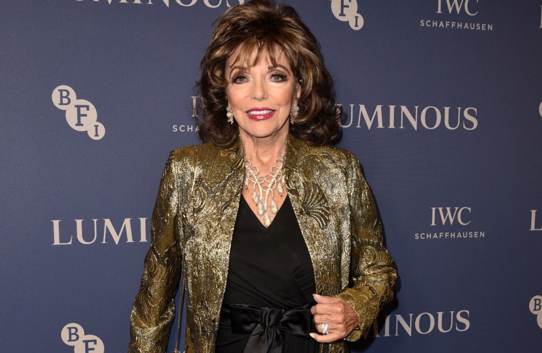 Dame Joan Collins couldn't move for two months after suffering from a trapped nerve