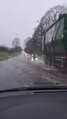 Drivers on A49 push through flood water and heavy rain near Church Stretton