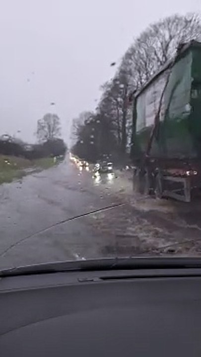 Drivers on A49 push through flood water and heavy rain near Church Stretton