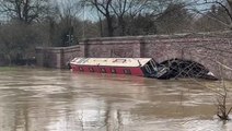 Storm Henk flooding traps canal boat against bridge as river swells