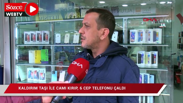 Kaldırım taşı ile camı kırıp, 6 cep telefonu çaldı