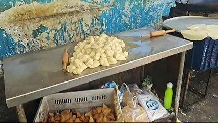 Food is prepared for passengers at the station amid filth