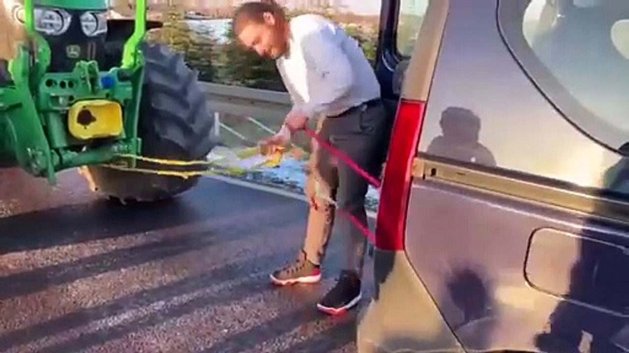 WATCH: #German ecology activist tried to tow one of the farmer's tractors with his Dacia
