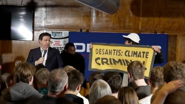 Moment security guard tackles protester at DeSantis campaign event in Iowa