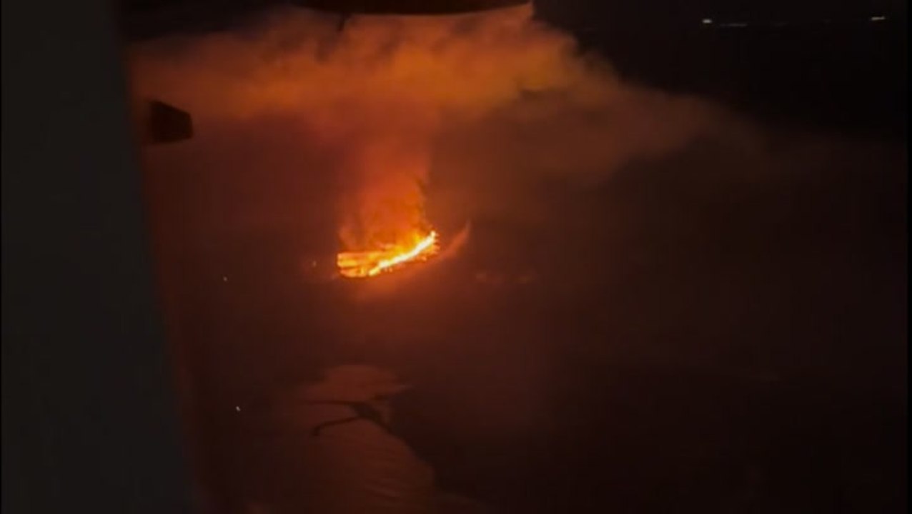 Erupting volcano captured from above by plane passengers during Iceland landing